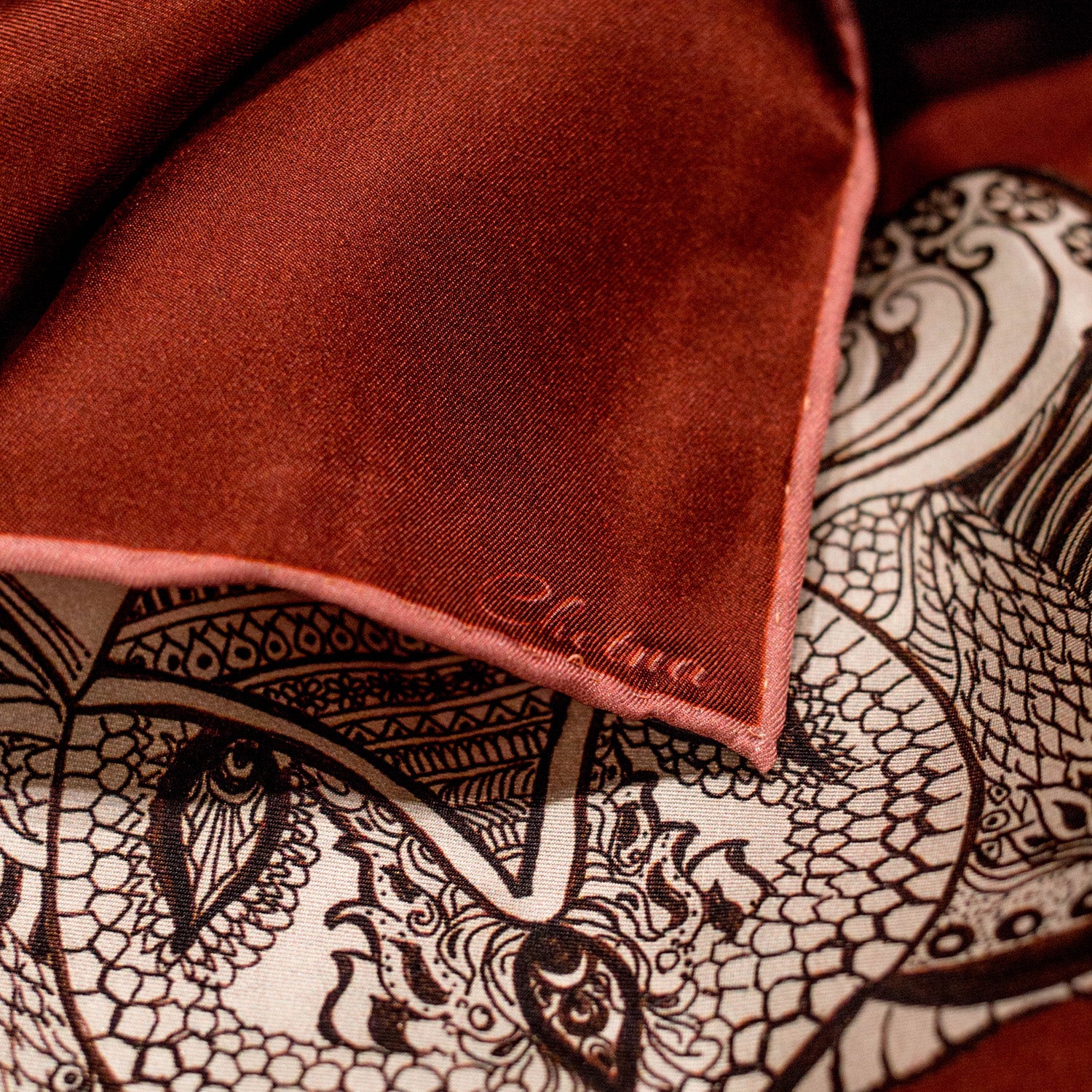 Close-up of Chetna Singh orange and rust tone elephant print long silk scarf. 