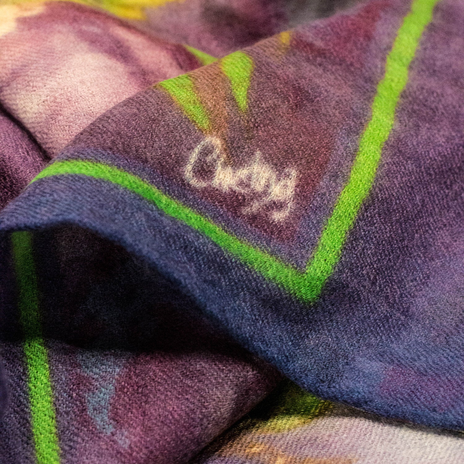 Close-up of Chetna Singh purple and green printed Phoenix cashmere scarf.