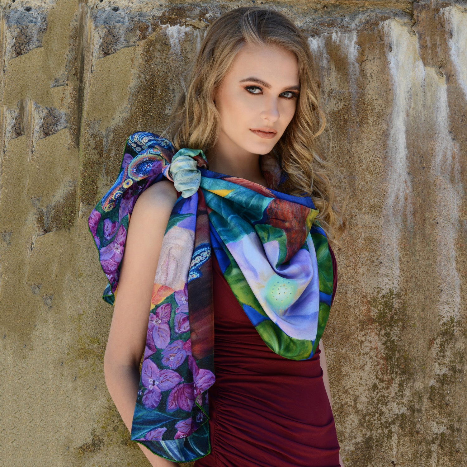 Model wearing Chetna Singh bold jewel tone bird and floral print long silk scarf.