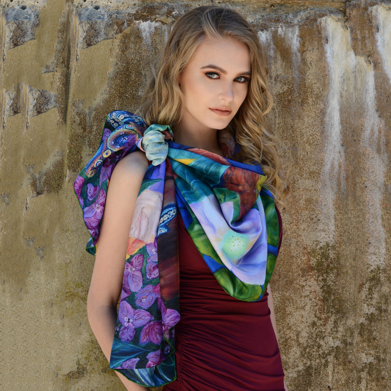 Model wearing Chetna Singh bold jewel tone bird and floral print long silk scarf. 