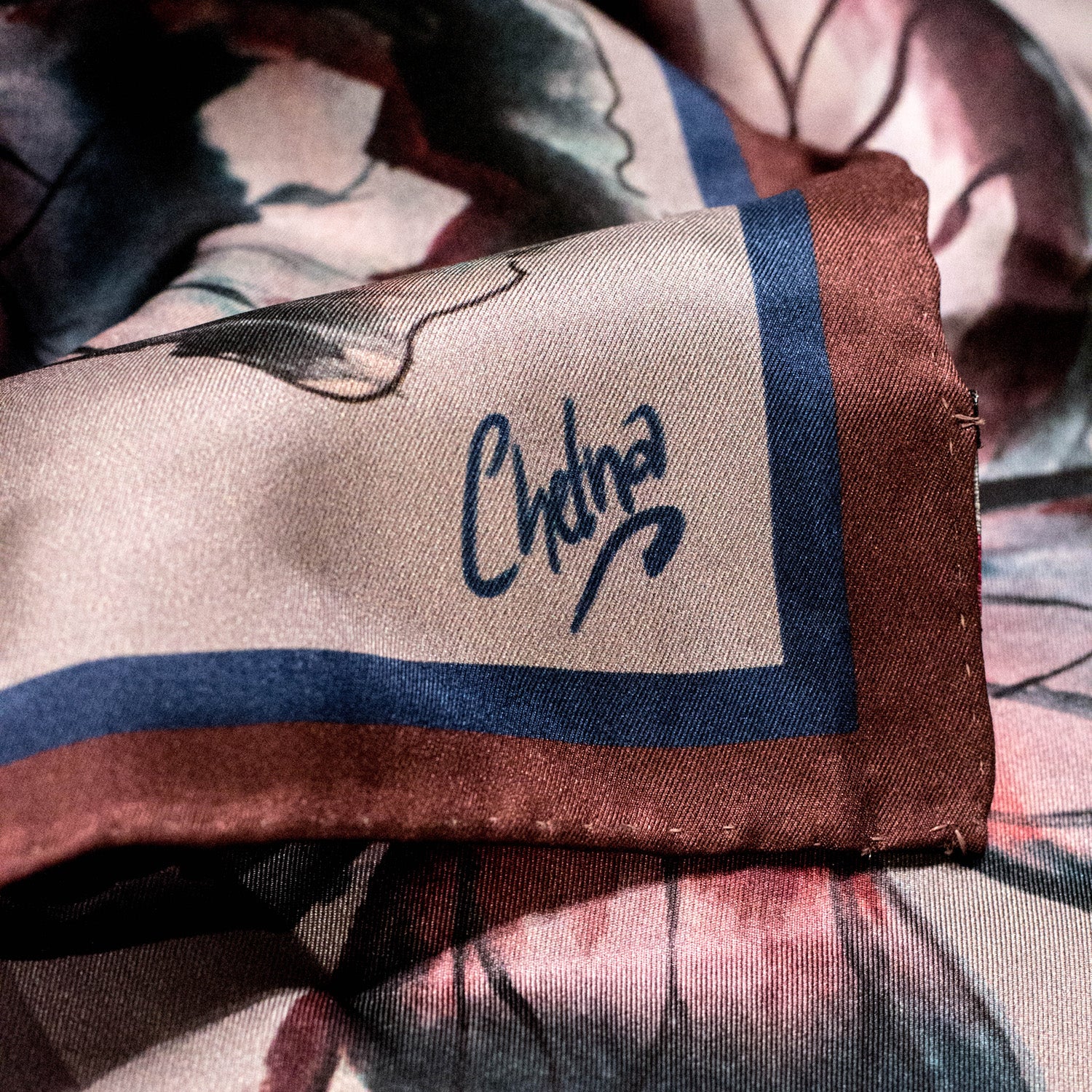 Close-up of Chetna Singh grey butterfly print square silk scarf.