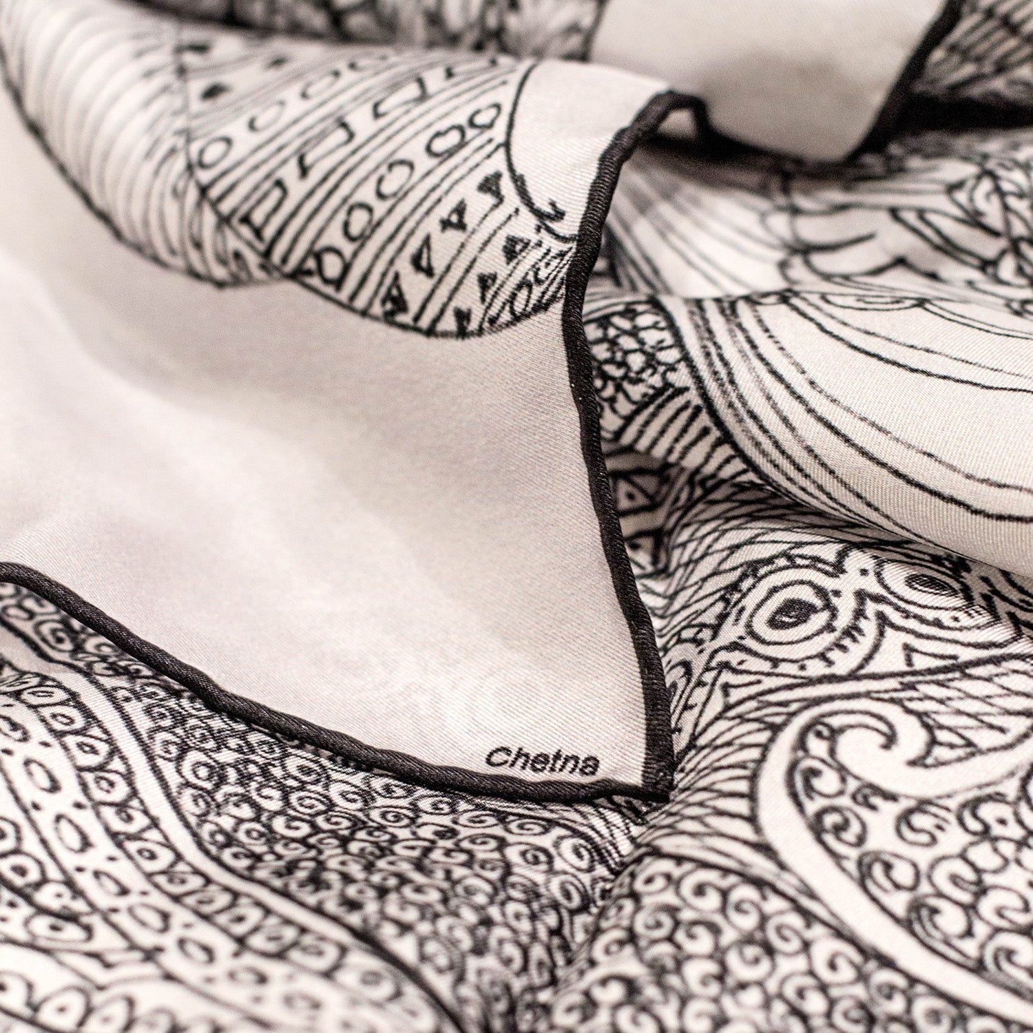 Close-up of Chetna Singh white henna horse print long silk scarf. 