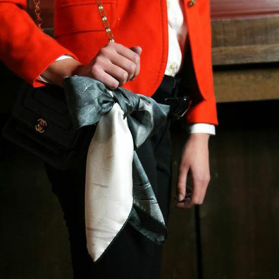 Woman wearing Chetna Singh black and white horse print silk scarf.