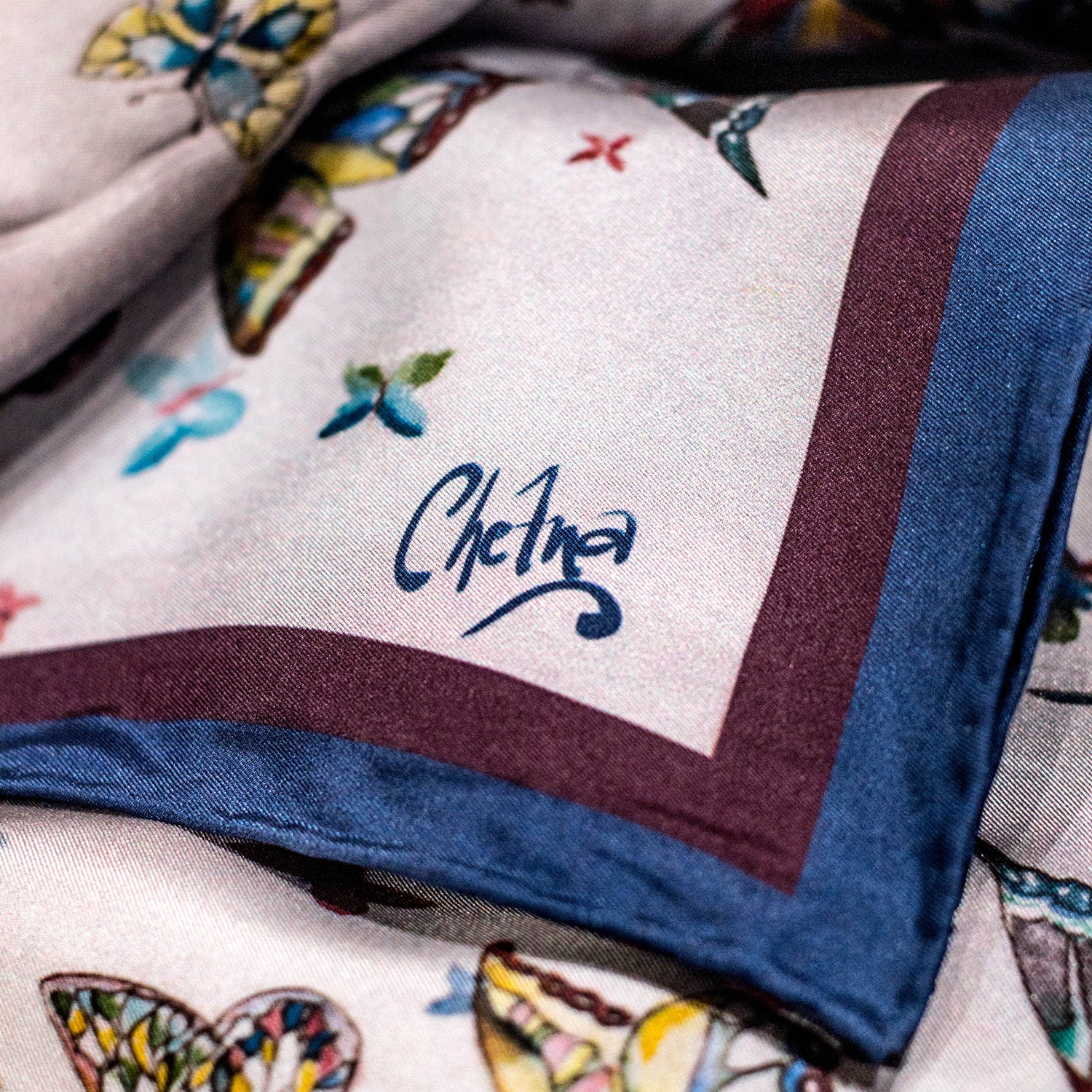 Close-up of Chetna Singh butterfly print long silk scarf. 
