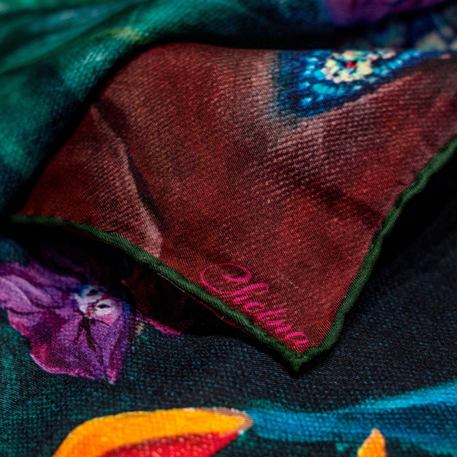 Close-up of Chetna Singh bold jewel tone bird and floral print long silk scarf. 