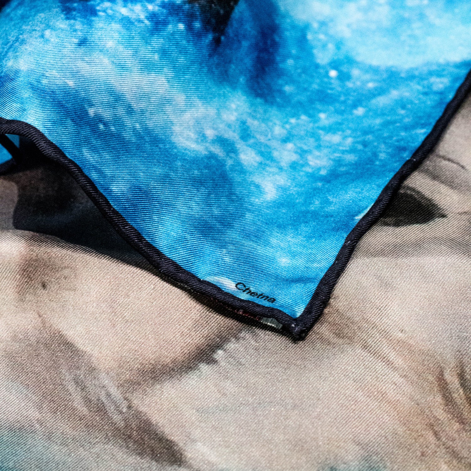 Close-up of Chetna Singh deep blue horse print square silk scarf. 
