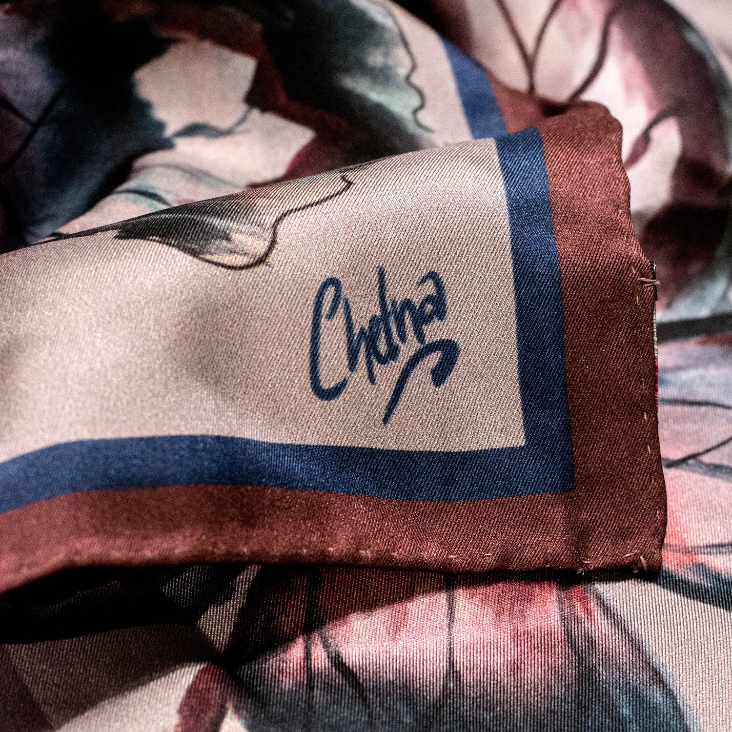 Close-up of Chetna Singh grey butterfly print square silk scarf. 